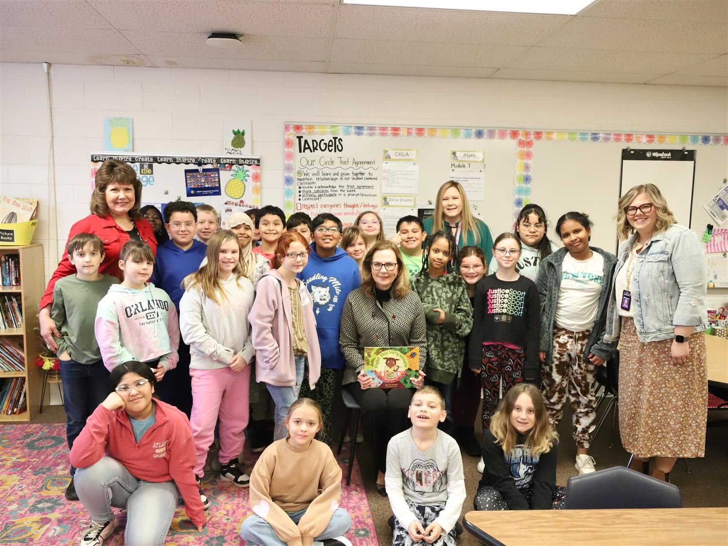 Nebraska First Lady, Suzanne Pillen, smiling with Seedling Mile Elementary 4th Graders and Teachers.