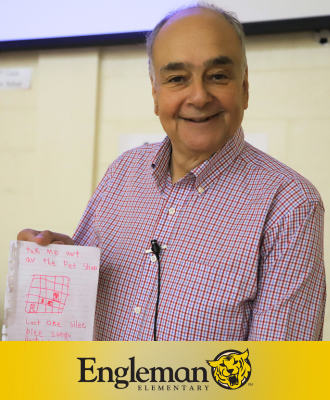  Alan Katz, Children's Book Author, smiling with a student's original work at Engleman Elementary