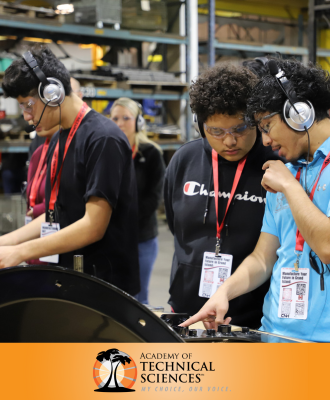  GISH Students in headsets exploring machinery on the Chief Fabrication manufacturing floor.