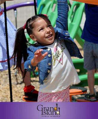  Photo of pre-school student holding onto the monkey bars at recess with the GIPS logo.