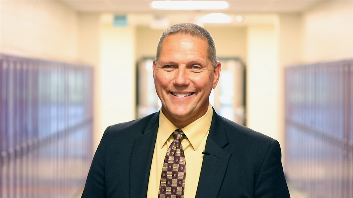 Matt Fisher, GIPS Superintendent, smiling in Barr Middle School hallway.